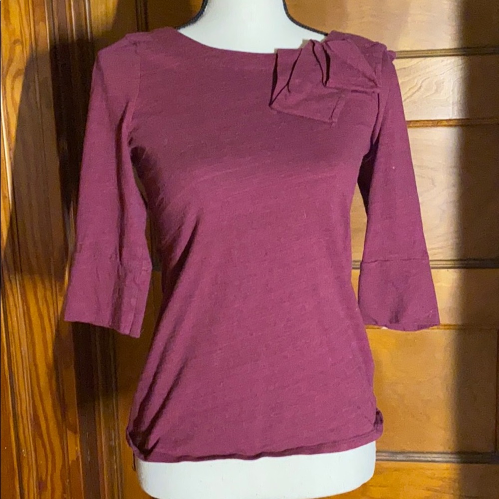 Plum tee w bracelet sleeves and shoulder corsage